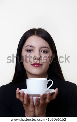 woman holding up a cup of coffee or tea waiting to have a nice drink