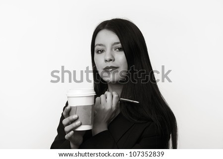 business woman holding up a paper coffee cup on the go