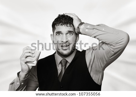 stress out business man pulling at his hair and squashing a paper coffee cup