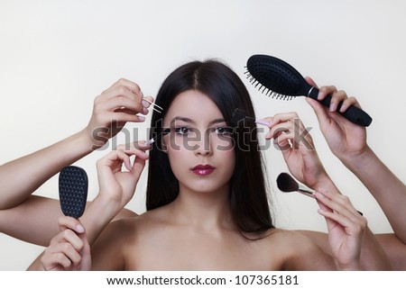 woman putting make up on with six arms to help