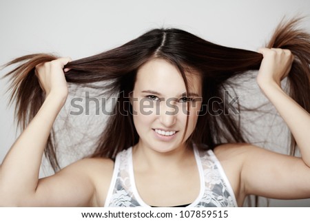 young woman looking like she having a bad hair day things are not going right