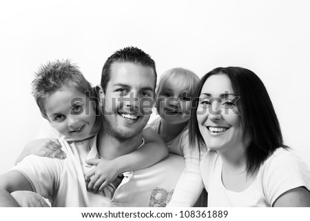 family of four group portrait mum, dad, boy and girl shot in the studio on a white background