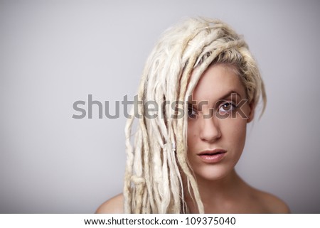 sexy woman with dreadlocks hair with hair down one side of her face
