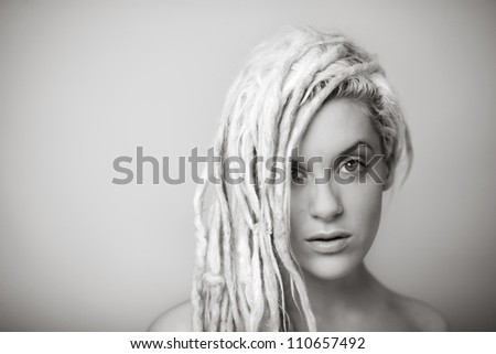 sexy woman with dreadlocks hair with hair down one side of her face