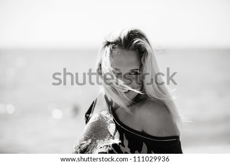 portrait of a sexy woman with the ocean behind her on a hot sunny day
