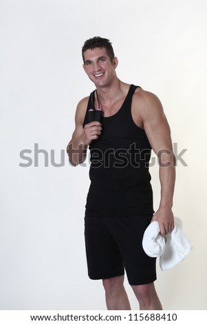 male bodybuilder with a skipping rope around his neck after a good work out holding a towel