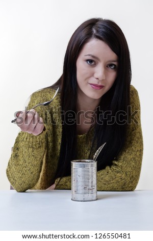 poor student eating cold food from the tin