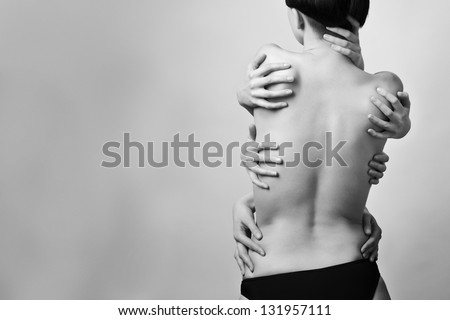 Portrait of the beautiful half naked woman back with many hands upon her