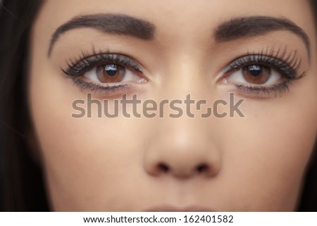attractive head shot of asian woman shot in the studio looking at camera