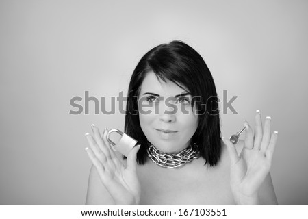 portrait of sexy woman with chain wrapped around her neck holding a pad lock and key