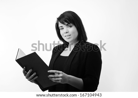 business portrait of a young woman reading from a large notepad