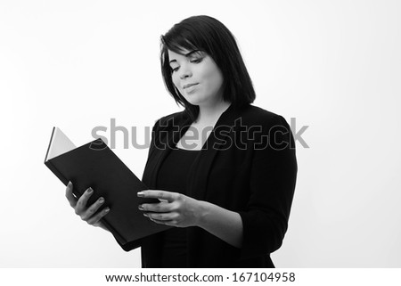 business portrait of a young woman reading from a large notepad