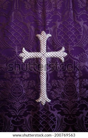 embroidered religious cross on  fabric background detail
