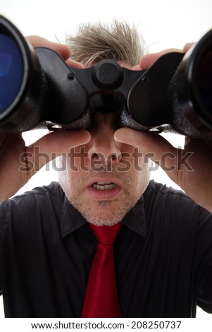 business man looking through binoculars shot close up