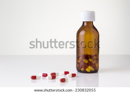 pills and pill bottle shot in the studio on white perspex background