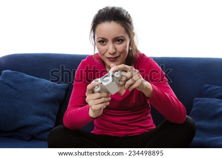 woman sitting on a sofa playing a game on a games consoles controller