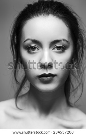 black and white portrait of a young woman with messy hair