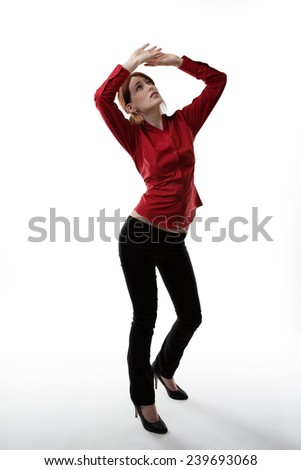 stand woman with arms up above her head as if she is protecting  her self from falling objects