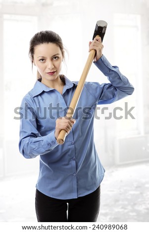 business woman holding a large sledgehammer get ready for trouble