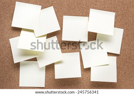 plain cork pin board with post it notes stuck to it