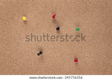plain cork pin board with pins in it