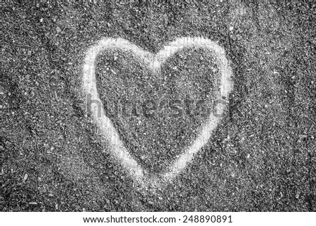 love heart shape made in the surface of saw dust
