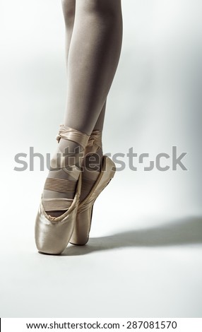 single ballerina close up of her shoes as she has gone on the end of her toes