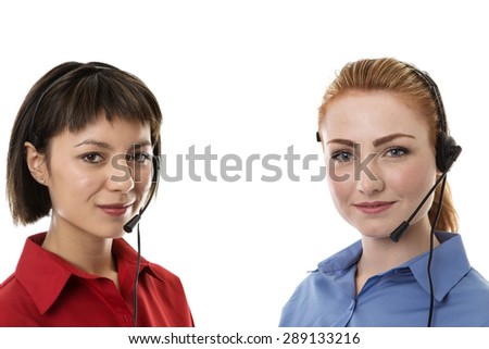 Two business woman wearing headset working hard to make you happy