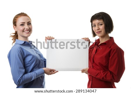 two business woman holding up a blank canvas frame for you to put anything you want to say on it