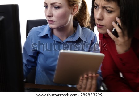 two work colleagues working together in the office looking like something is wrong
