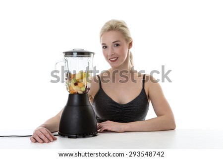 happy fitness woman making a smoothie