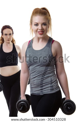 two woman working out and keeping fit lifting weights