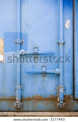 side on view of door handles and locks of a large metal container