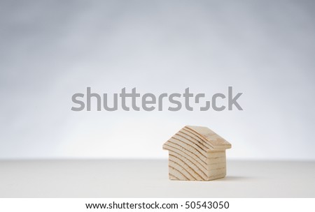 small wooden model house on plan white background