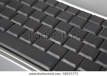 close up detail image of a laptop keyboard with all the letters, symbol and character missing