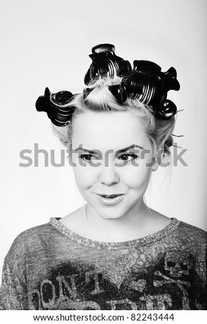 teen aged girl with her hair in roller getting ready to go out