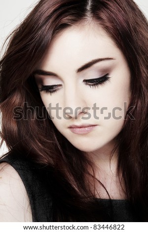 close up portrait of a young woman crying make up running down face