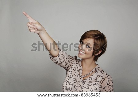good looking woman pointing her finger at something