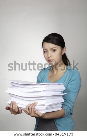 woman hold a lot of paper almost to much to carry