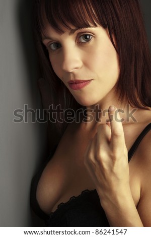 woman in black underwear looking sexy gesturing with her finger for you to come near
