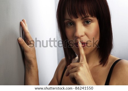 woman in black underwear looking sexy with finger up to mouth telling you to be  quiet
