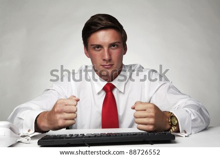 business man at hitting his desk and not very happy about something