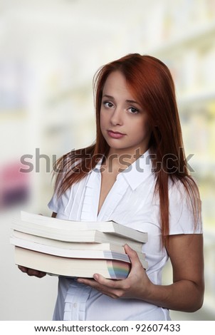 red hair woman carrying a few books