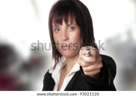 woman point out with a pen in her hand point at the viewer
