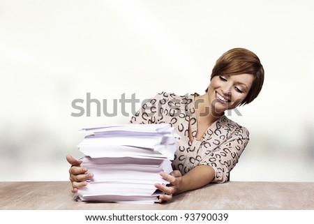 woman at her desk with lots of paper work to do