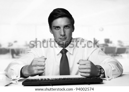 business man at hitting his desk and not very happy about something