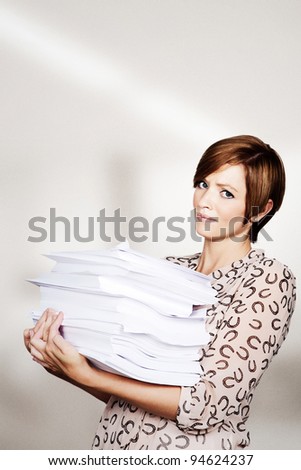woman holding a big pile of paper work
