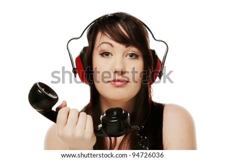 woman on the phone with ear defenders on so she cant hear what the person on the other end of the phone has to say