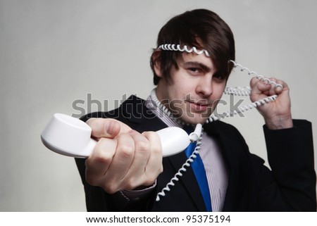 business man on the phone who got all wrapped up in the cord not the best of call