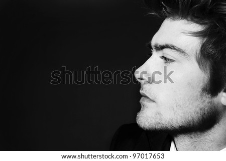 low key image of side profile of a young man